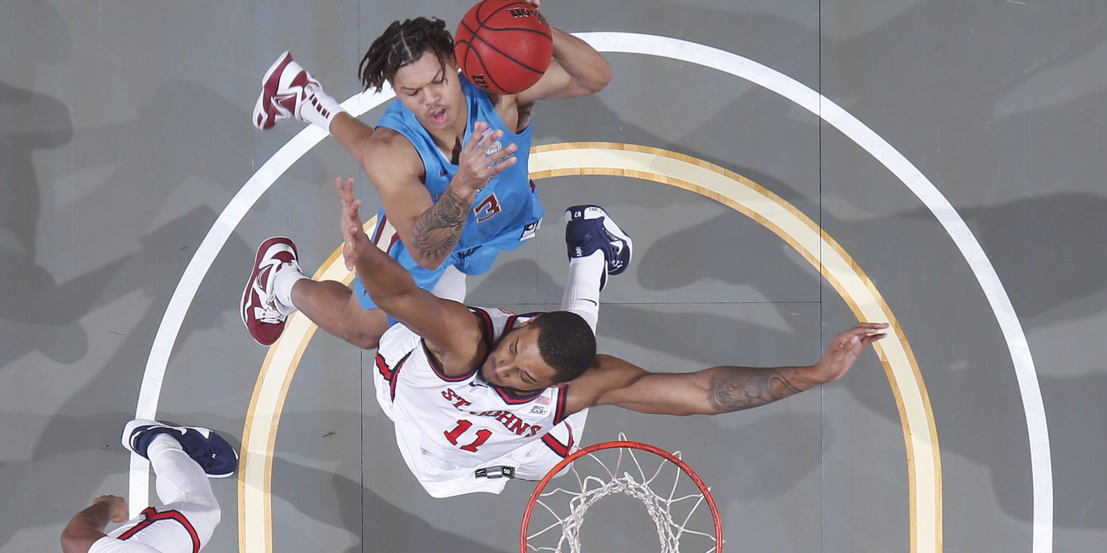 Florida Seminoles basketball player Cameron Corhen attempts to score