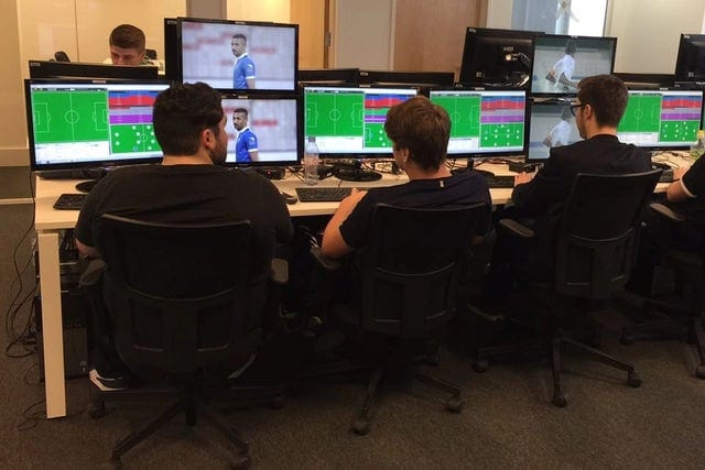 football analysts analysing a match on their computers in an office